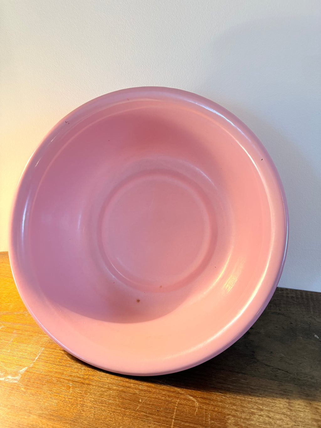 Two vintage enamel basins in soft blush pink and powder blue