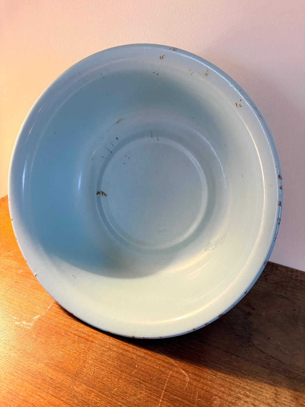Two vintage enamel basins in soft blush pink and powder blue