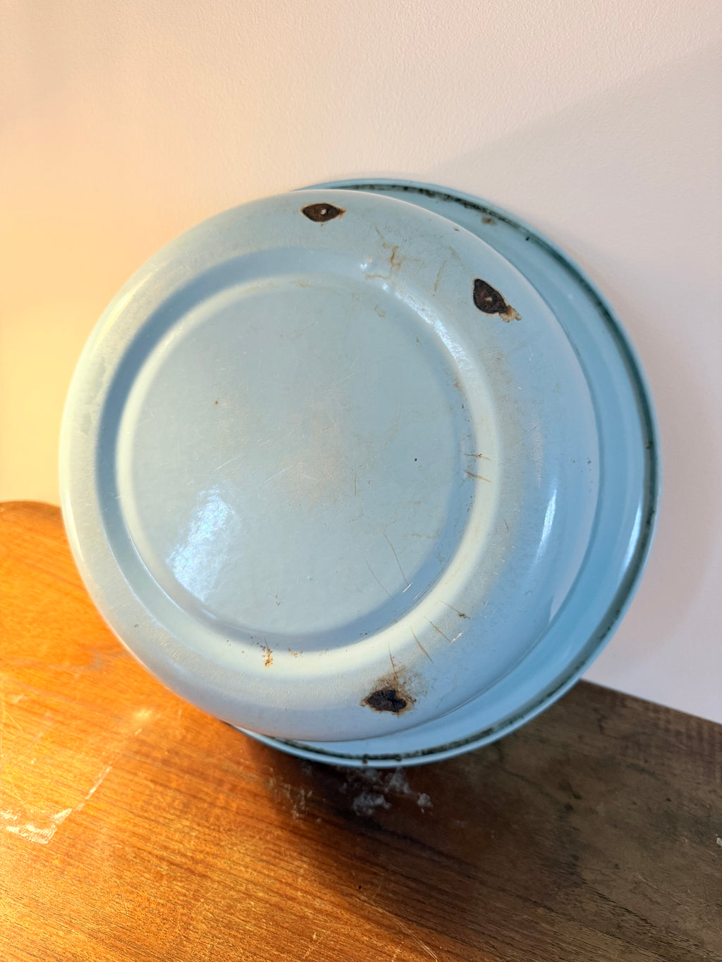 Two vintage enamel basins in soft blush pink and powder blue