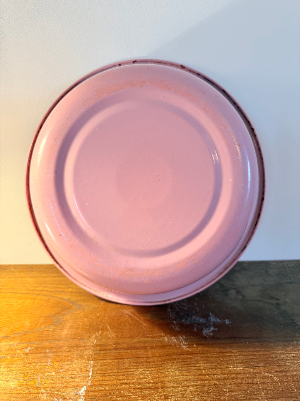Two vintage enamel basins in soft blush pink and powder blue